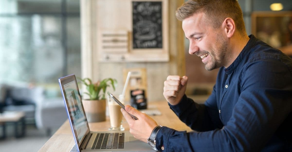 happy business person viewing his laptop happy business person viewing his laptop