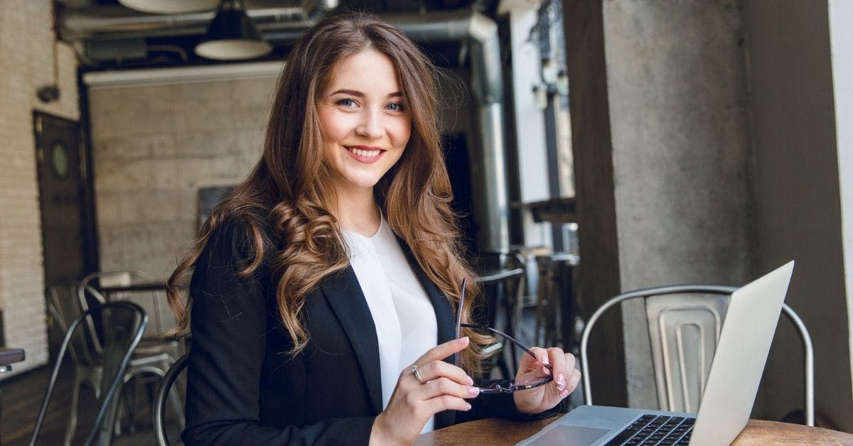 women business owner smiling in a cafe
